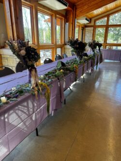 Plum purple and lavender wedding details with fairy lights at Prairie Oak Lodge in Marion Iowa