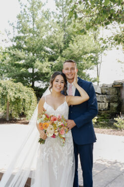 Wedding at Bella Sala venue in Tiffin Iowa with playful pink accents and wildflowers