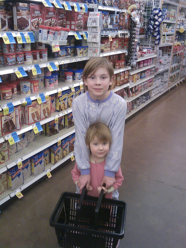 Buying chocolate in the store with my two pajama/moon-boot wearing kids