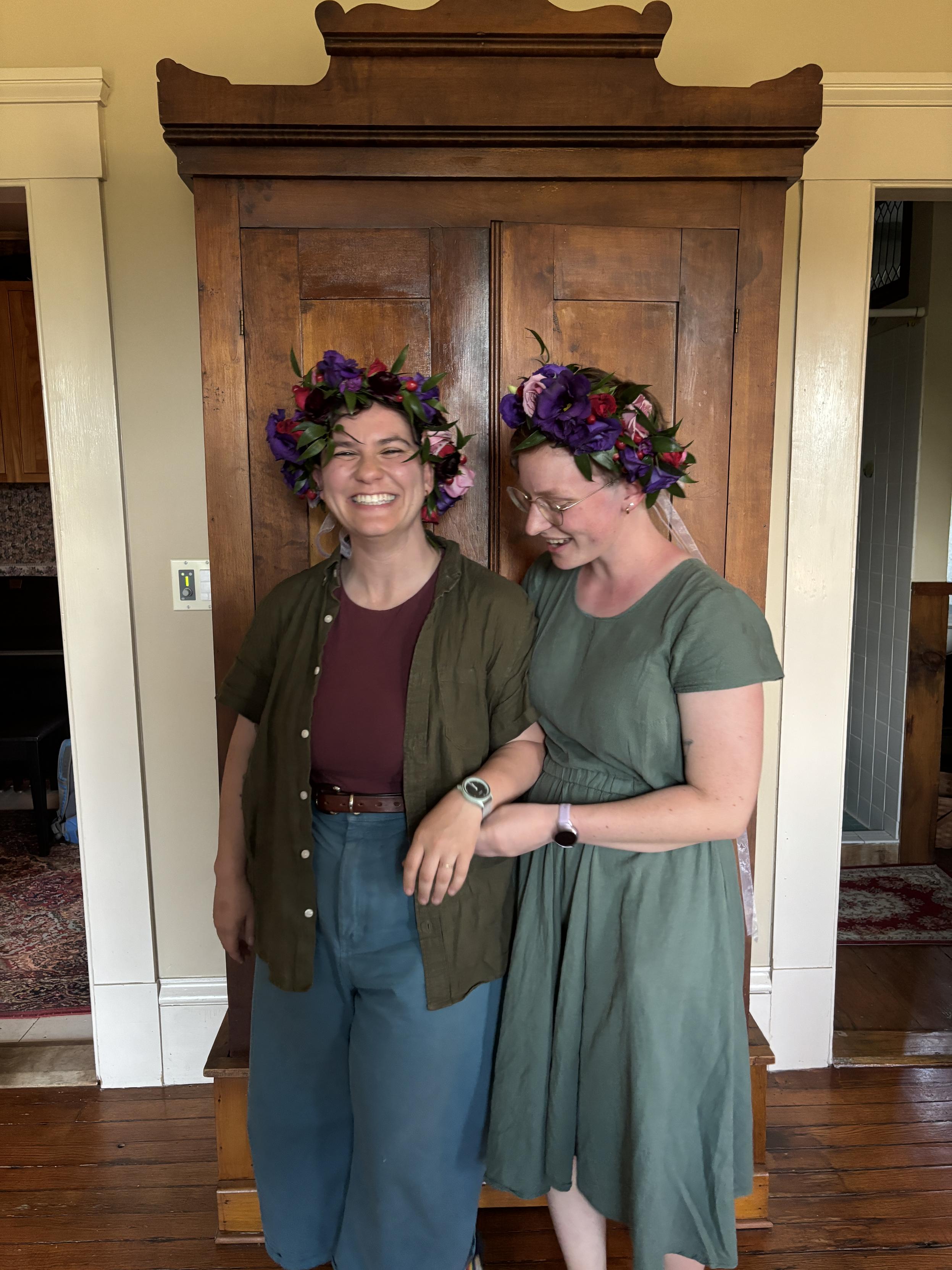 Now the lesbians are in front of a wardrobe, and wearing flower crowns