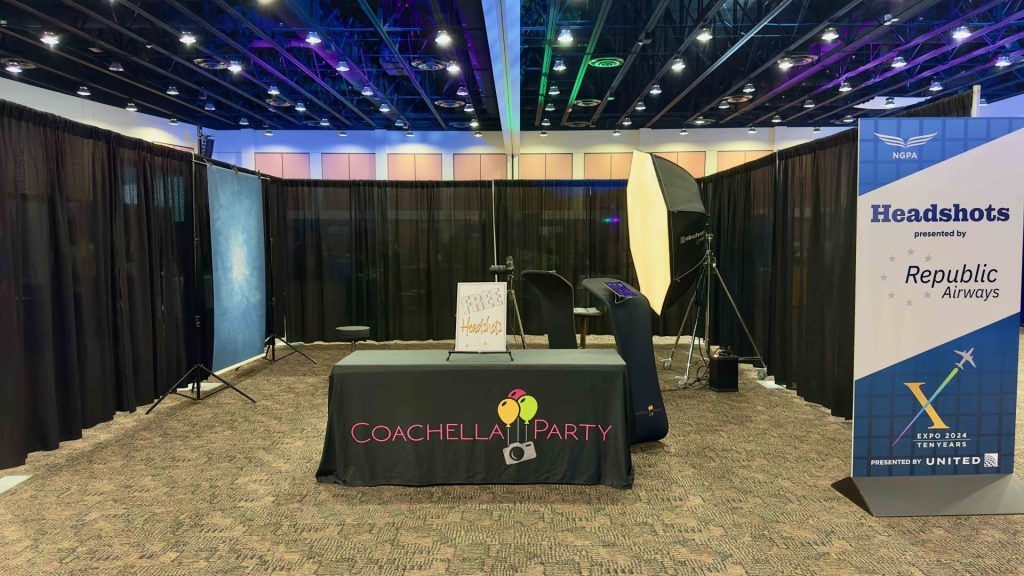 A headshot station set up on a conference floor with attendees waiting