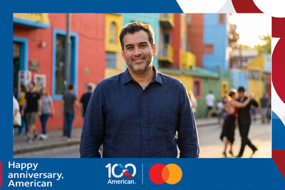 AI travel photo experience for American Airlines' 100th anniversary with Mastercard: a guest stands in the colorful La Boca district of Buenos Aires as tango dancers perform behind him.