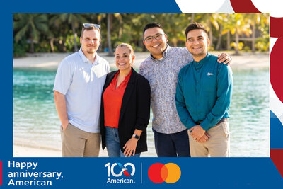 AI travel photo experience for American Airlines' 100th anniversary with Mastercard: four guests gather on a palm-lined beach beside a turquoise lagoon.