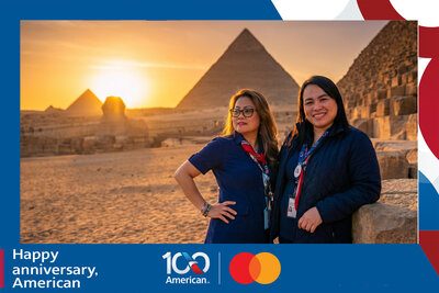 AI travel photo experience for American Airlines' 100th anniversary with Mastercard: two guests at the Pyramids of Giza and the Sphinx in warm sunset light, Egypt.
