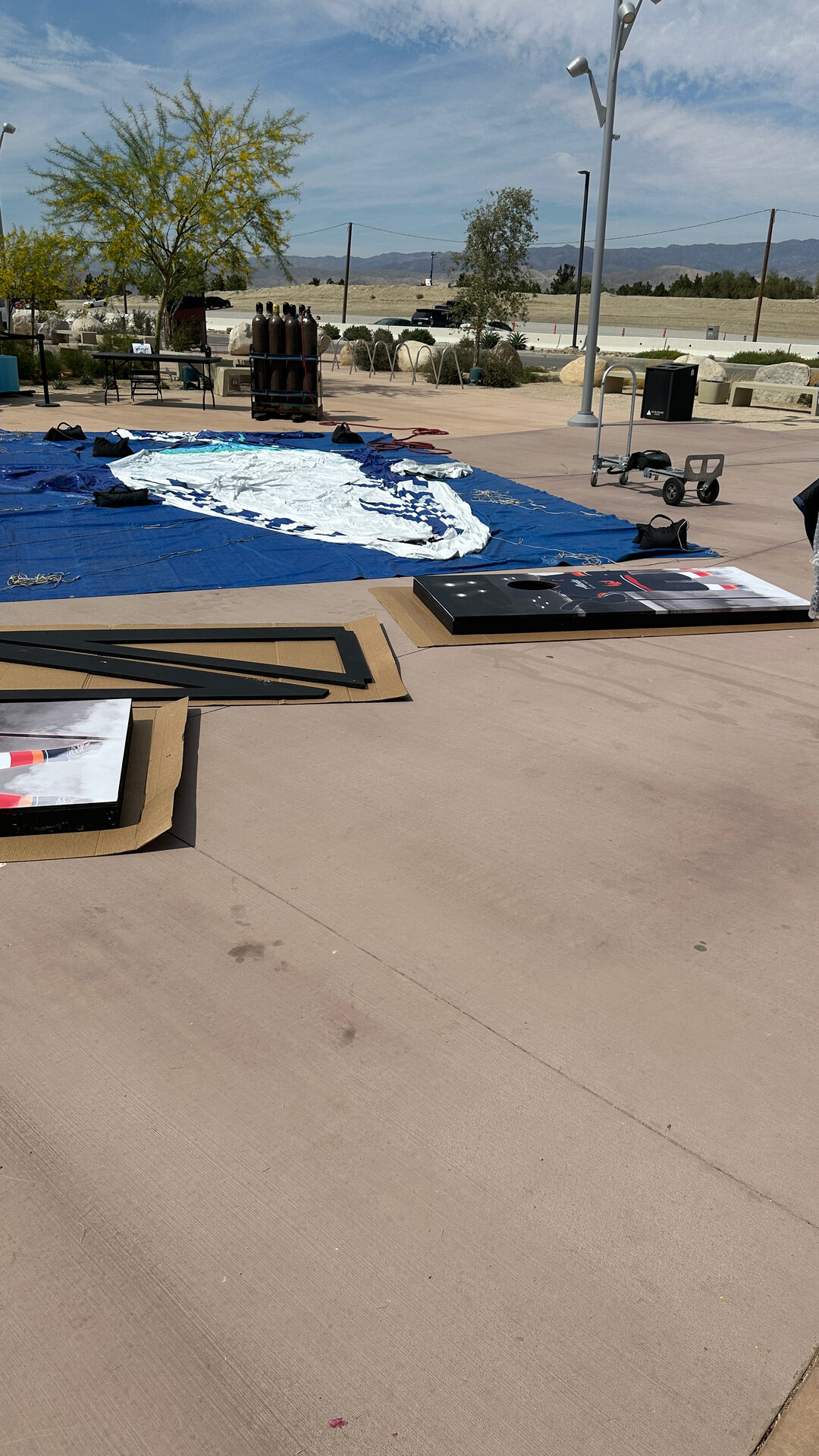 Blue activation mat laid out on the concourse with the arena behind