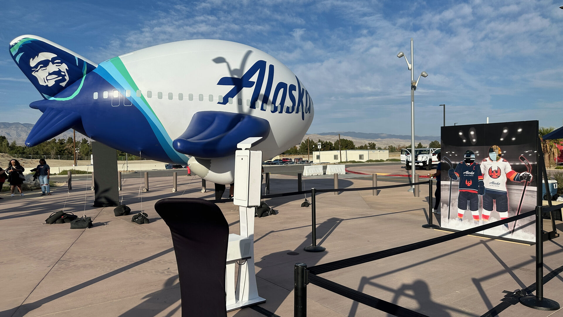 Guest using a photo booth in front of the Alaska plane livery