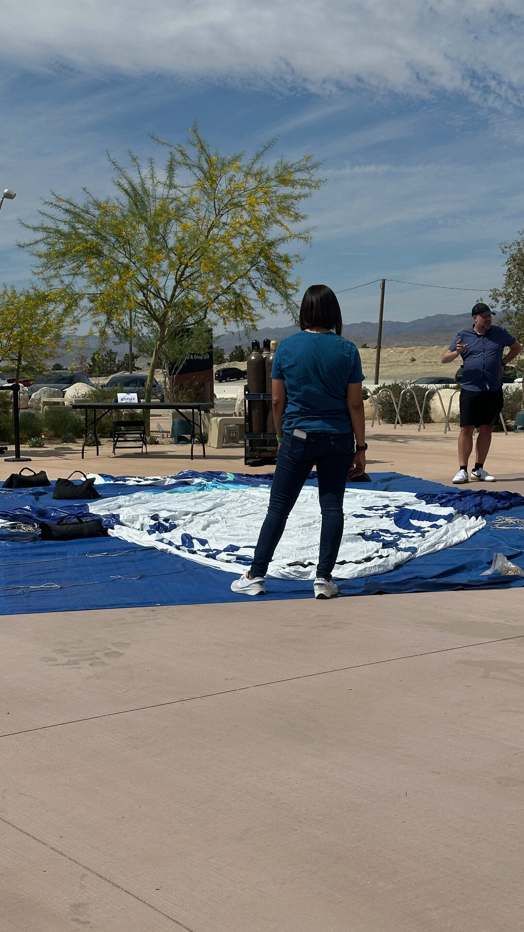 Crew laying a blue activation mat on the arena concourse