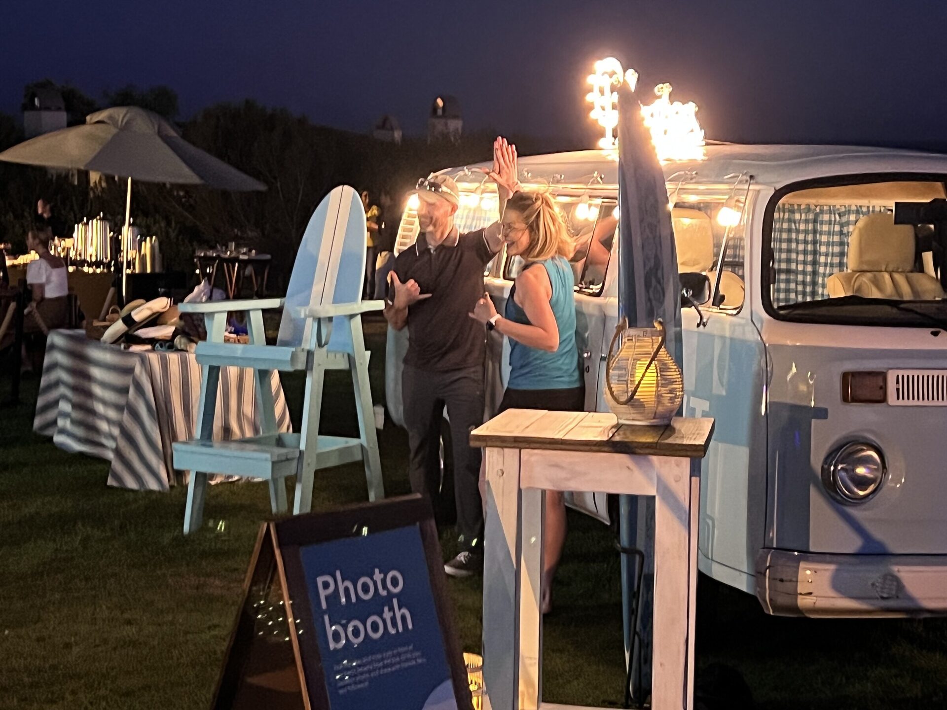 The VW photo bus lit at dusk with guests beside it on the lawn at Terranea Resort, Rancho Palos Verdes