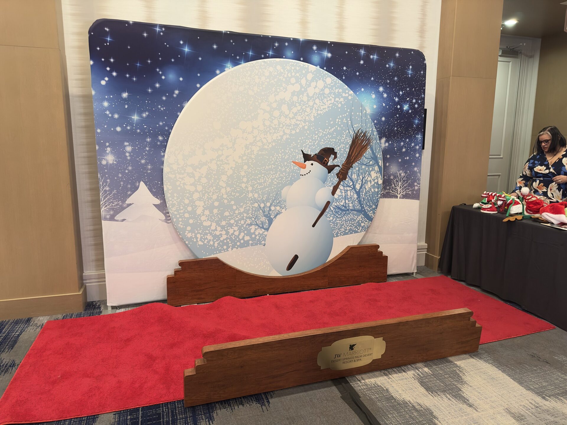 A custom snow globe photo booth set with a snowman and red carpet built for the holiday party at JW Marriott Desert Springs, Palm Desert