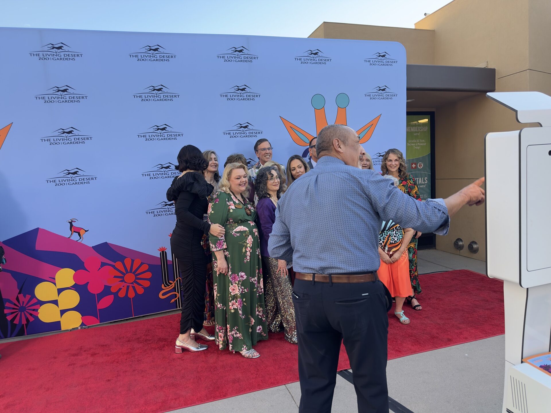 Guests on the red carpet at a branded Living Desert Zoo and Gardens step-and-repeat with the photo booth attendant in Palm Desert