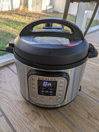 Instant pot electric pressure cooker on a back porch