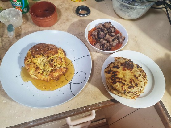 Home made flatbread, baked beans with pork sausage and Libum.