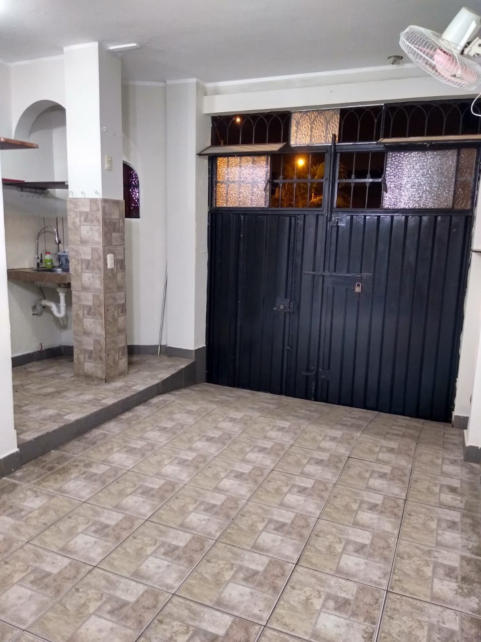 SALA COLINDA CON LA COCINA  Y PUERTA DE SALIDA A LA CALLE