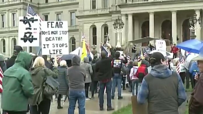 Whitmer’s stay-at-home orders protested outside Michigan Captiol as scuffle breaks out