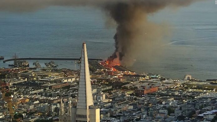 Firefighters are battling a 4-alarm fire on Pier 45 in San Francisco