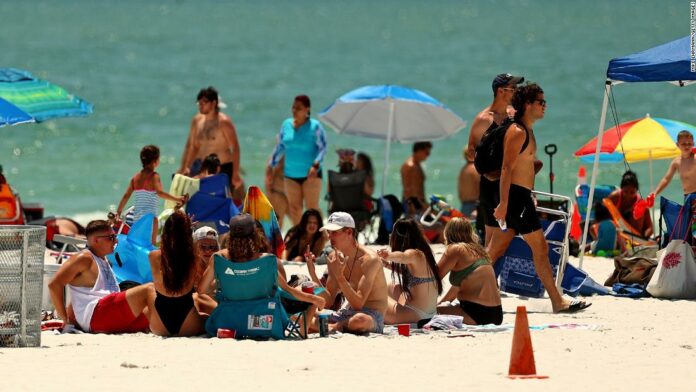 Memorial Day weekend: Americans visit beaches and attractions with pandemic warnings in mind
