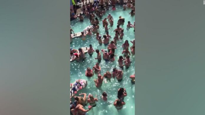 Pool party at Lake of the Ozarks, Missouri shows people crowding closely together