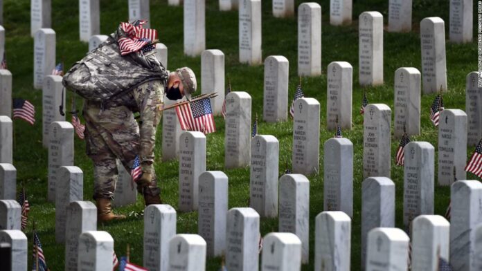 Solemn rituals remain but with new precautions at Arlington National Cemetery this Memorial Day