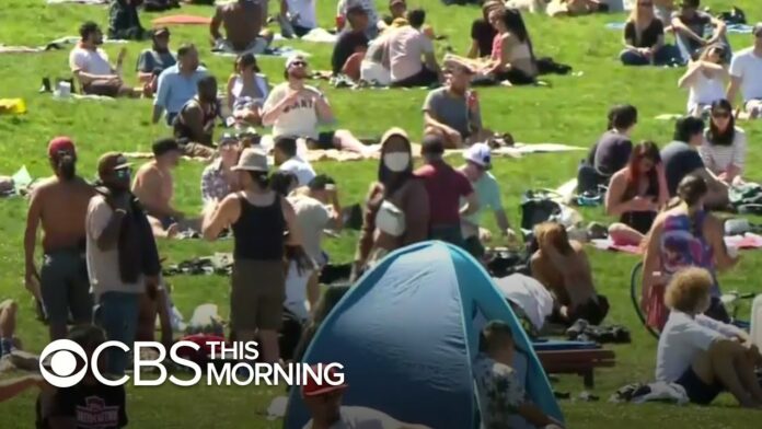 Despite COVID-19 risks, Americans swarm beaches across the country