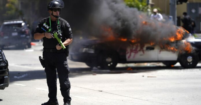 L.A. imposes curfew as police and protesters in standoff