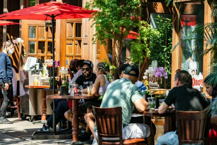 After 100 days, New York City opens for haircuts, outdoor dining, as virus cases soar in 12 other states