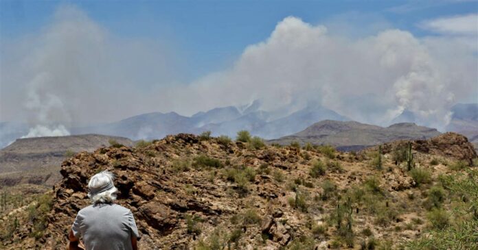 Giant wildfire near Phoenix continues to grow as Arizona coronavirus cases spike