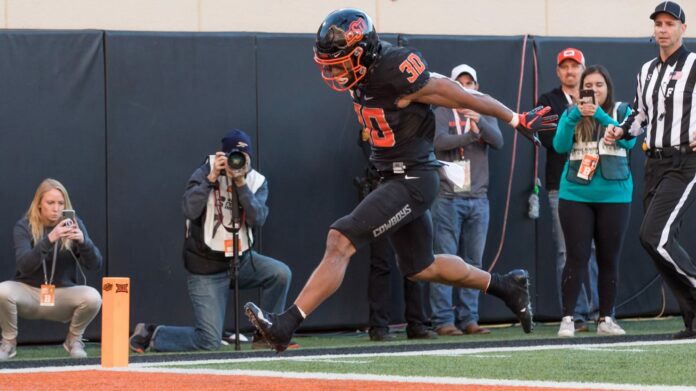 Oklahoma State’s Chuba Hubbard Threatens Boycott Over Coach Mike Gundy’s OAN Tee