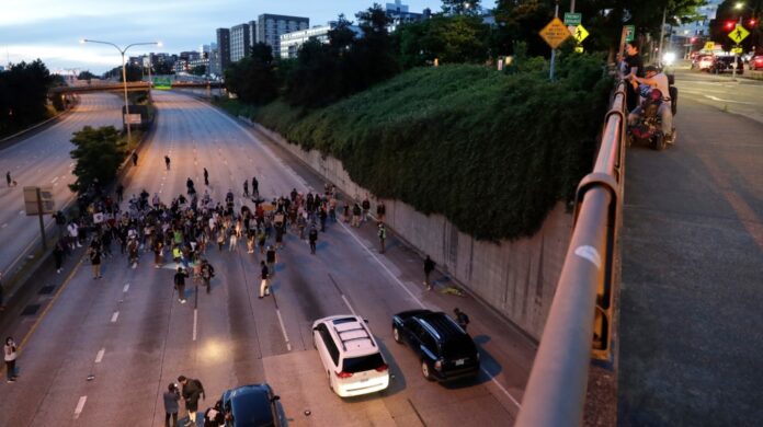 Car slams into two protesters on closed Seattle highway