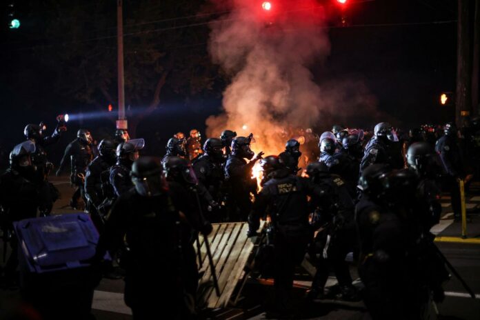 Portland protesters throw fire bombs at officers on 100th day of demonstrations
