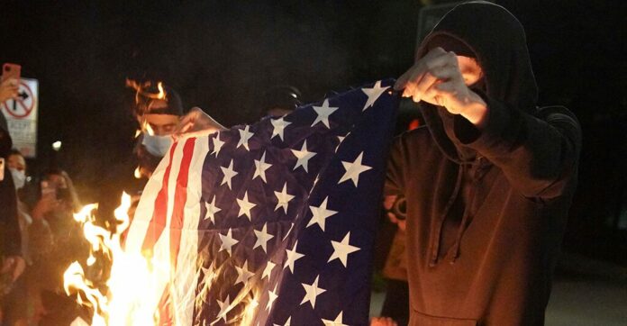 Portland unrest prompts arrests; objects thrown at officers, flag burned: reports