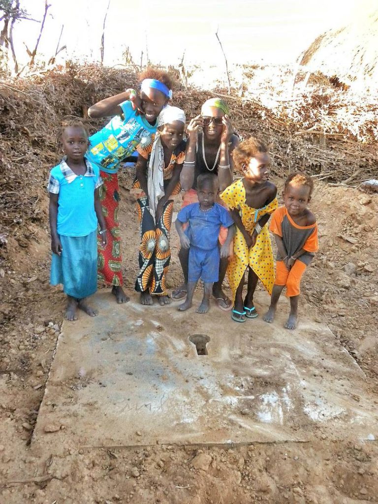 Tada! Kids with the new latrine before clean up and fence.