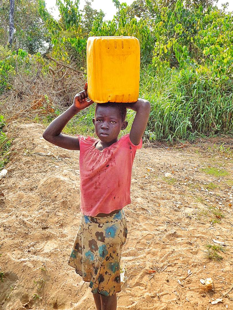 A Child Carrying Water
